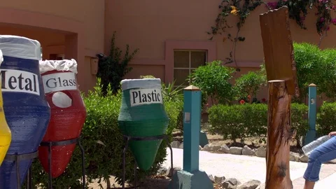 Girl throwing a plastic bottle in the plastic dustbin in slow motion Stock Footage 81231516