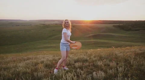 Girl throws his straw hat into the camera Stock Footage 64321121