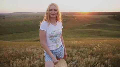 Girl throws his straw hat into the camera Stock Footage 64376447