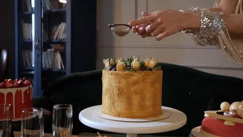 The girl throws the icing on the cake Stock Footage 126369925