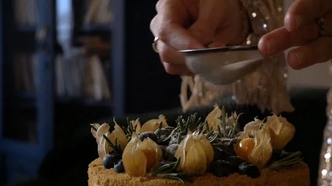 The girl throws the icing on the cake Stock Footage 126369958