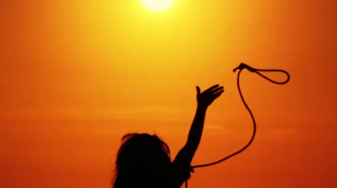Girl throws a rope to the sun at sunset (Silhouette) Stock-Footage 33648087