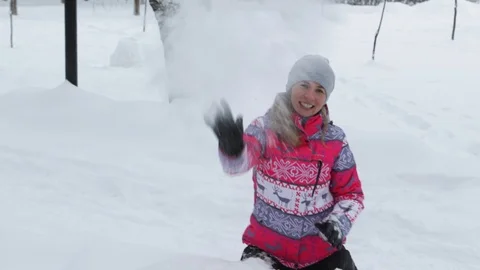 A girl throws snow into the camera Stock Footage 85486826