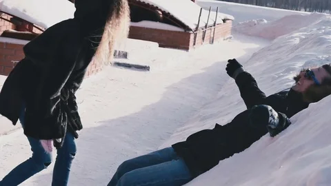 Girl throws snow on the guy Stock Footage 80532867