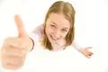 The girl thumbs up to the camera. View from above Photo