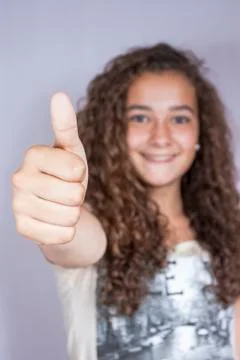 Girl with thumbs up, happy and successful Stock Photos
