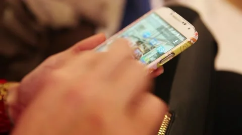 Girl thumbs through the menu on its phone Stock Footage 43306239