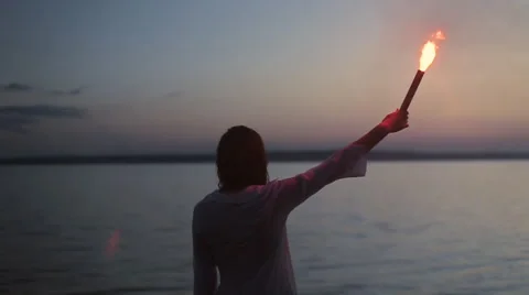 Girl with torch on the sea Stock Footage