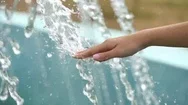 Girl Touches A Hand Stream Of Water From Fountain, Slow Motion  Stock Footage