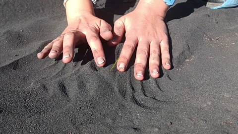 Girl touching ashes from an active volcano in the Canary Islands, vegetation Stock Footage 170524185