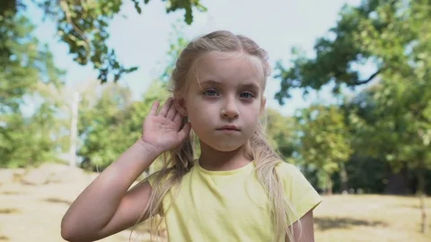 Girl touching ear, eavesdropping gossips, child hearing loss problem, deafness Video stock 117209159
