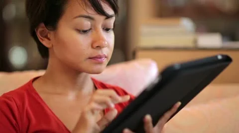 Girl touching tablet computer screen at home Video stock 12175930