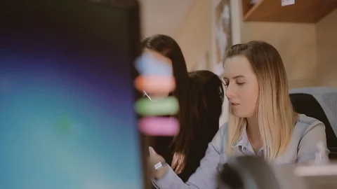 A girl trainee in the office asks for help from a colleague. Stock Footage 89669558