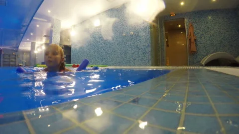 The girl is training in the pool using water sports equipment Stock Footage 106487424