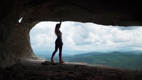 Girl traveler walks through the cavern. Cave city in the vicinity Bakhchisarai Stock Footage