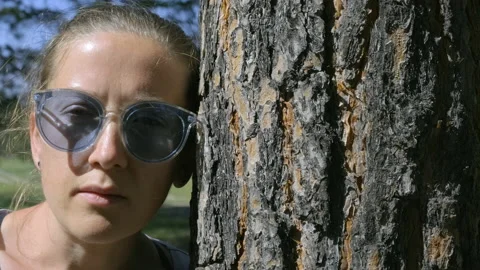 Girl by the tree. 4k Stock Footage 208266441