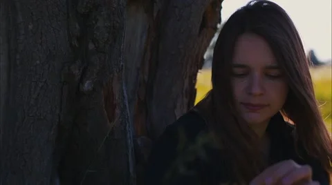 Girl at a Tree Eats Grass Stock Footage 52009198