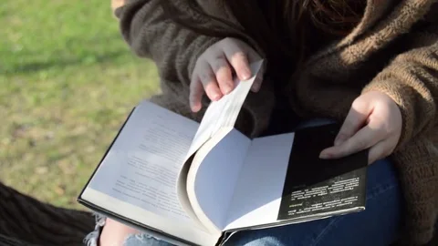 A girl on the tree reading a book Stock Footage 76901685