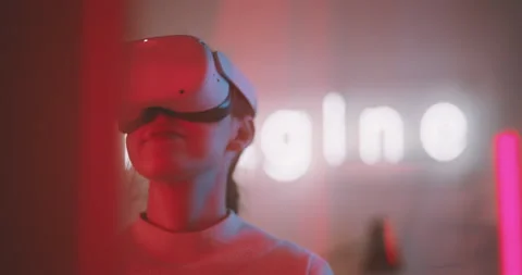 A girl trying and experimenting virtual reality in magenta neon light Stock Footage 201110777