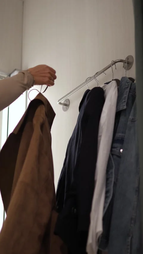 The girl is trying on clothes in the fitting room Stock Footage 289014281
