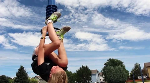 Girl trying to pull herself up on pole Vídeos de archivo 53768379