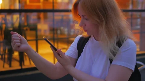 Girl trying to scanned a QR code on her hand and make a purchase Stockbeeldmateriaal 134634455