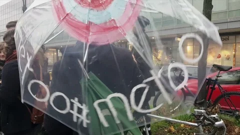 Girl twirls transparent umbrella with #Me Too on it at “Me Too” demonstration Stock Footage