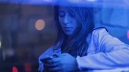 Girl Typing On Cellphone At Night Next To Neon Light. Candid Young Woman Hold Stock Footage