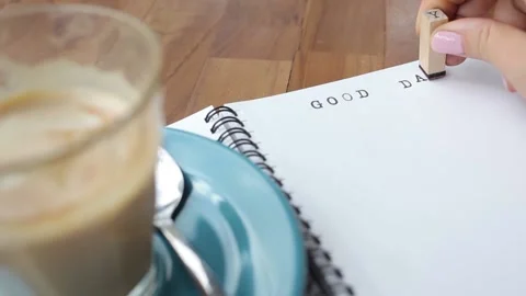 Girl typing GOOD DAY using stamp font and ink Video stock 163355159