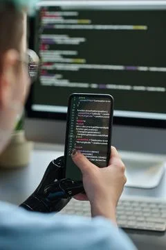 Girl typing program codes on smartphone 스톡 사진