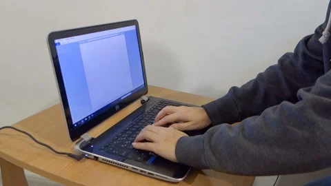 The girl is typing a text document on a laptop, working on a computer. Video stock 100657175