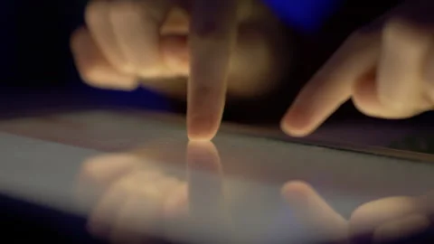 Girl Typing on Touch Screen Digital Tablet at Night. Hands of Person Typing.. Stock Footage 329448924