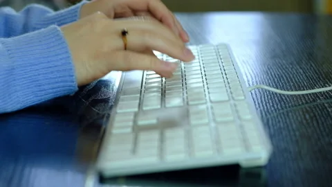 Girl is typing on a white keyboard. Stock-Footage 130478341