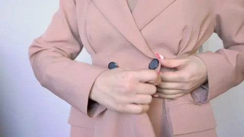 Girl is unbuttoning the Jacket Stock Footage 148126587