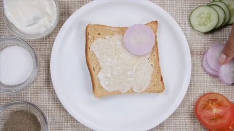 A girl under the process of making a healthy vegetable sandwich Stock Footage 112862246