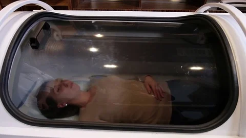 Girl is undergoing cosmetic procedure in the hyperbaric chamber Stock Footage