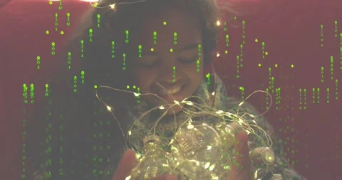 Girl unfolding light string and activating bulbs while binary overlay enhancing Stock Footage 318758602