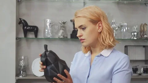 The girl is unhappy with the price of furniture fittings for the house Stock Footage