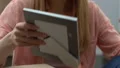 Girl unpacking personal items, holding photo frame, pleasant memories from past HD Footage