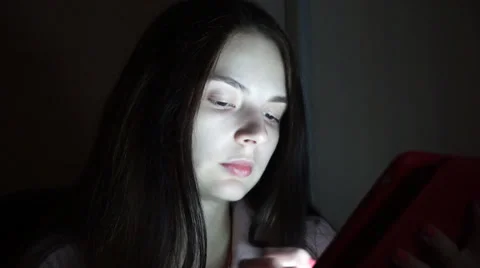 Girl uses the app in the computer tablet at night Video stock 54603636