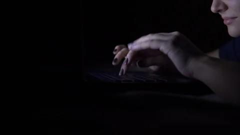 Girl uses a mobile computer lying on the bed at home at night. Isolated light Video stock 100722594