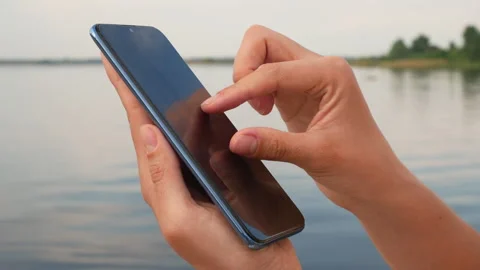 Girl uses smartphone sensor Stock Footage 243183930