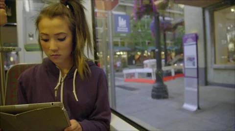 Girl uses tablet computer on train Stock Footage 54253075