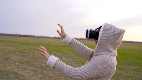Girl uses a virtual reality glasses outdoors Stock Footage 75155853
