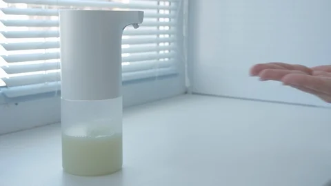 Girl using automatic foam soap dispenser, washing hands, close, macro, on the Video stock 129332979