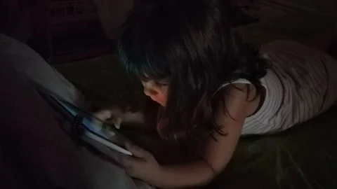 Girl using black tablet computer lying on black mat Stock Footage 152236527