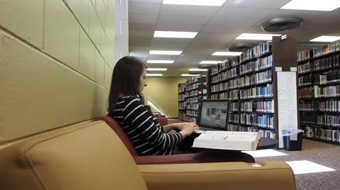 Girl using computer in a college library Stock Footage 46947785