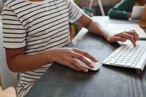 Girl using computer at desk Stock Photos