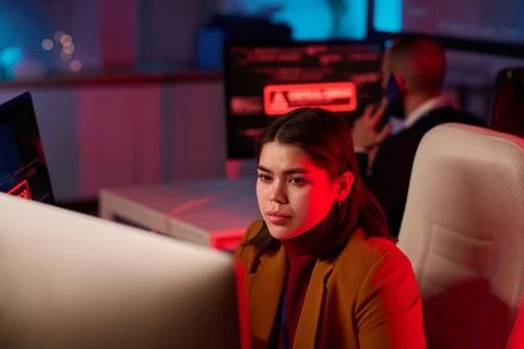 Girl using Computer in IT Office with Red Light Stock Photos