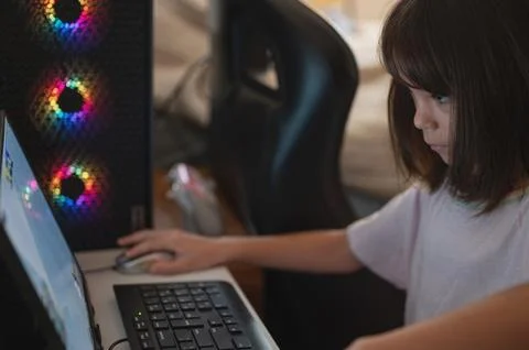 Girl using computer with keyboard and mouse Stock Photos